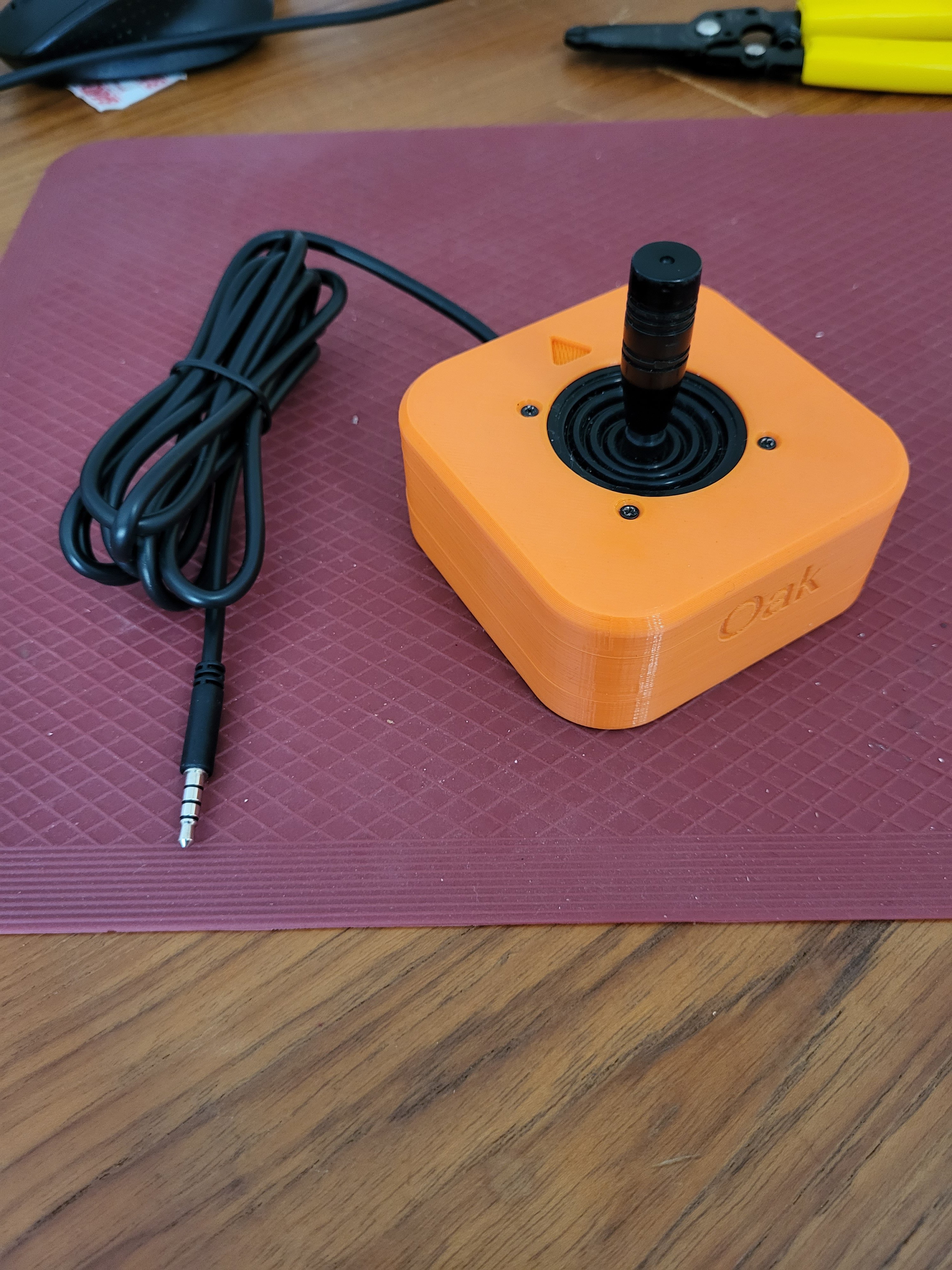 A photo of the Oak Compact Joystick printed in orange PLA.