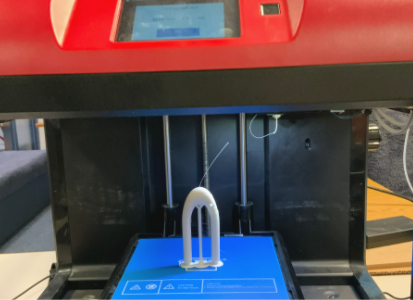 A u-shaped 3d printed device on the print bed of a 3d printer