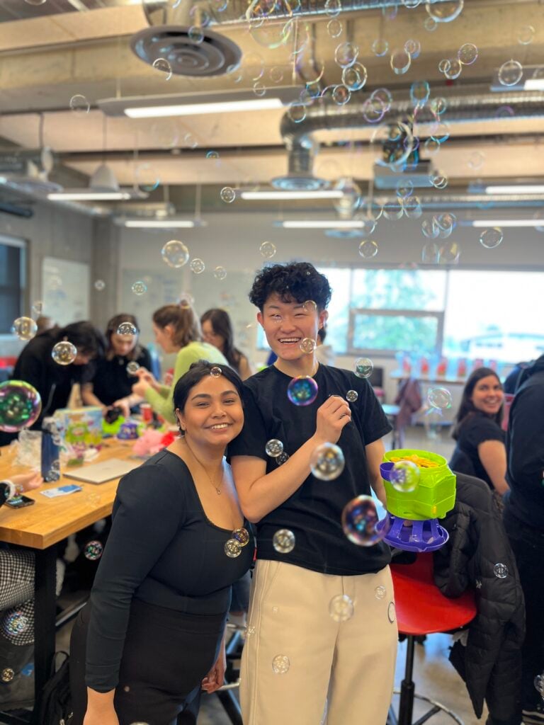 Participants at a UBC Enable build, holding a switch-adapted bubble blower.