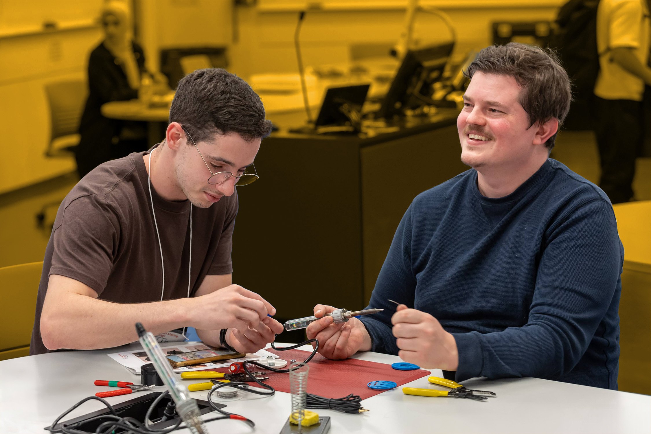 Two makers soldering 3d printed devices