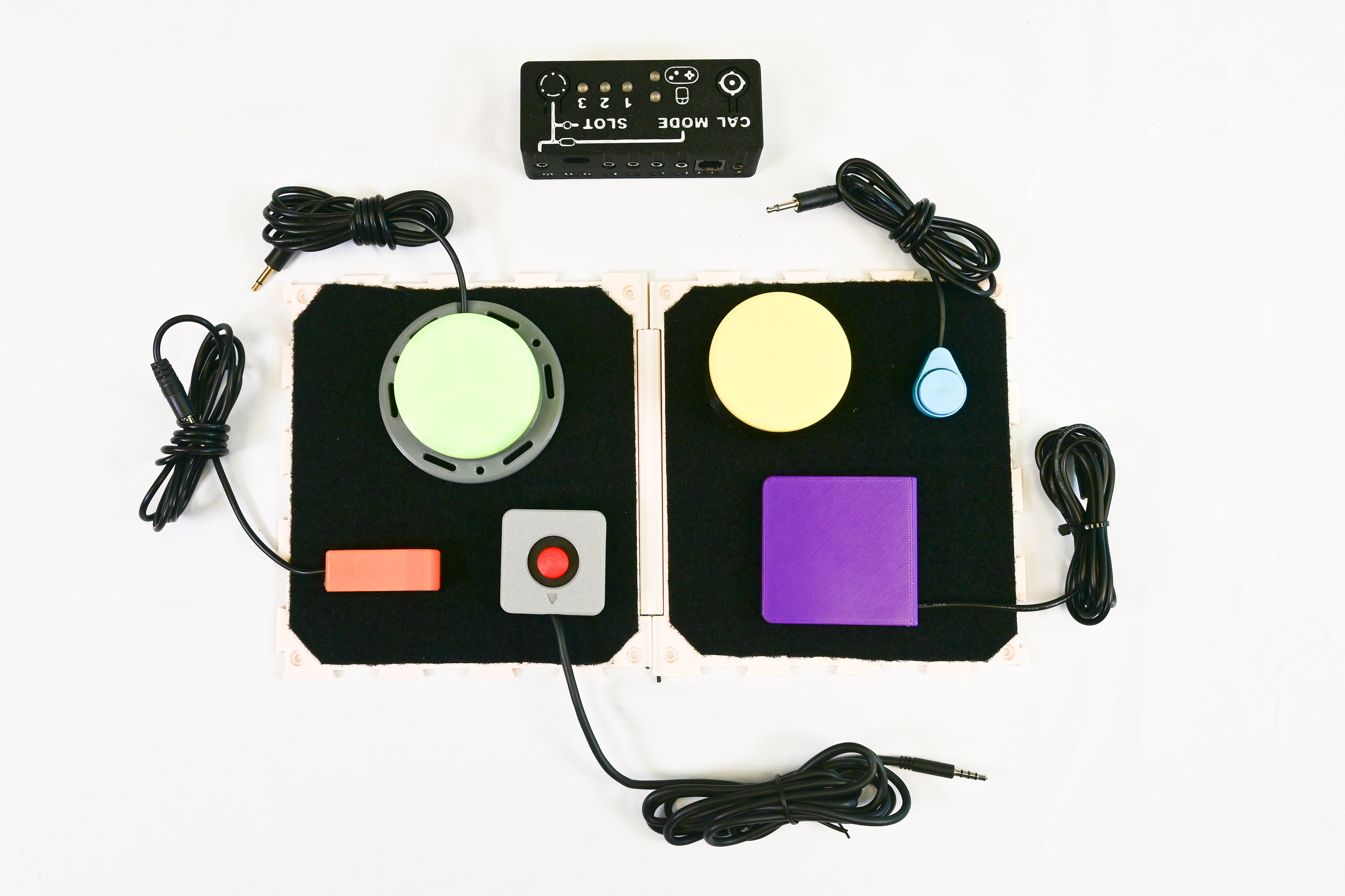 top down photo of various switches and joysticks on an MMC gaming tray with a forest hub.