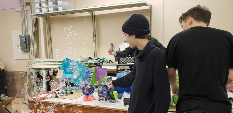 A volunteer looking at a switch-adapted bubble blower.