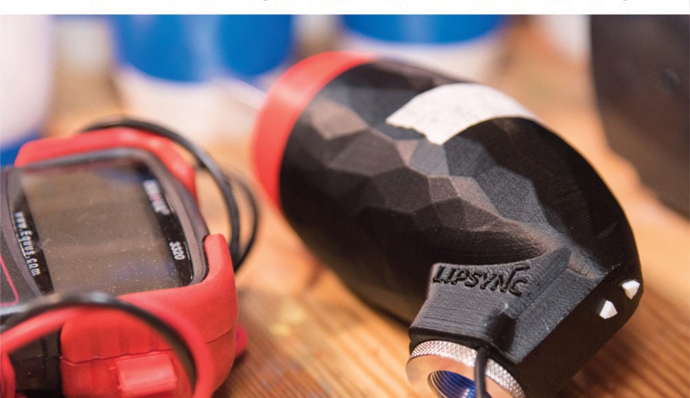 A black and red LipSync assistive device.