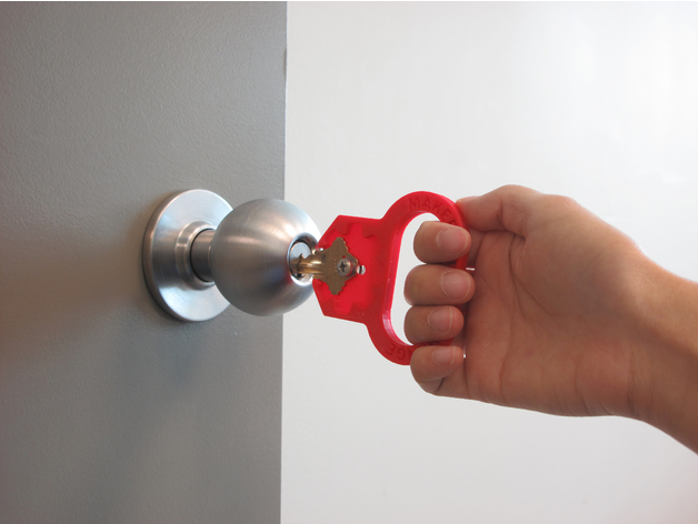 A red Key Turner being used to open a door.