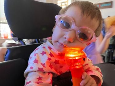 Raven wearing glasses holding her Spinning Light Wand.