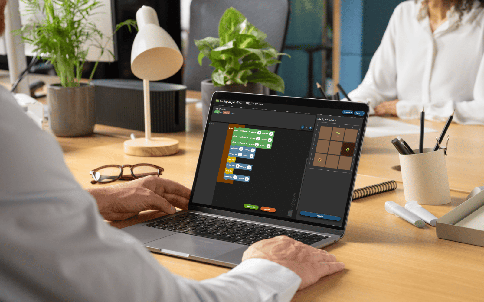 A person using a laptop with the screen showing CodingCrops