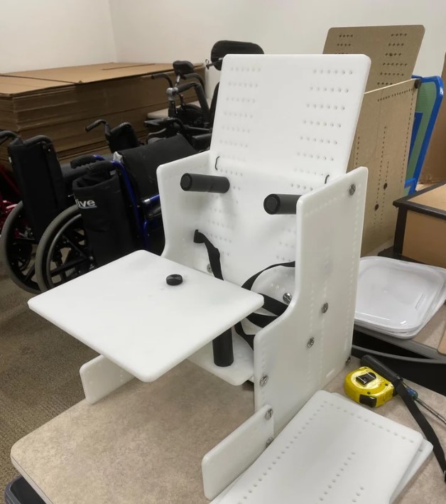 Therapy chair in white plastic sitting on a table