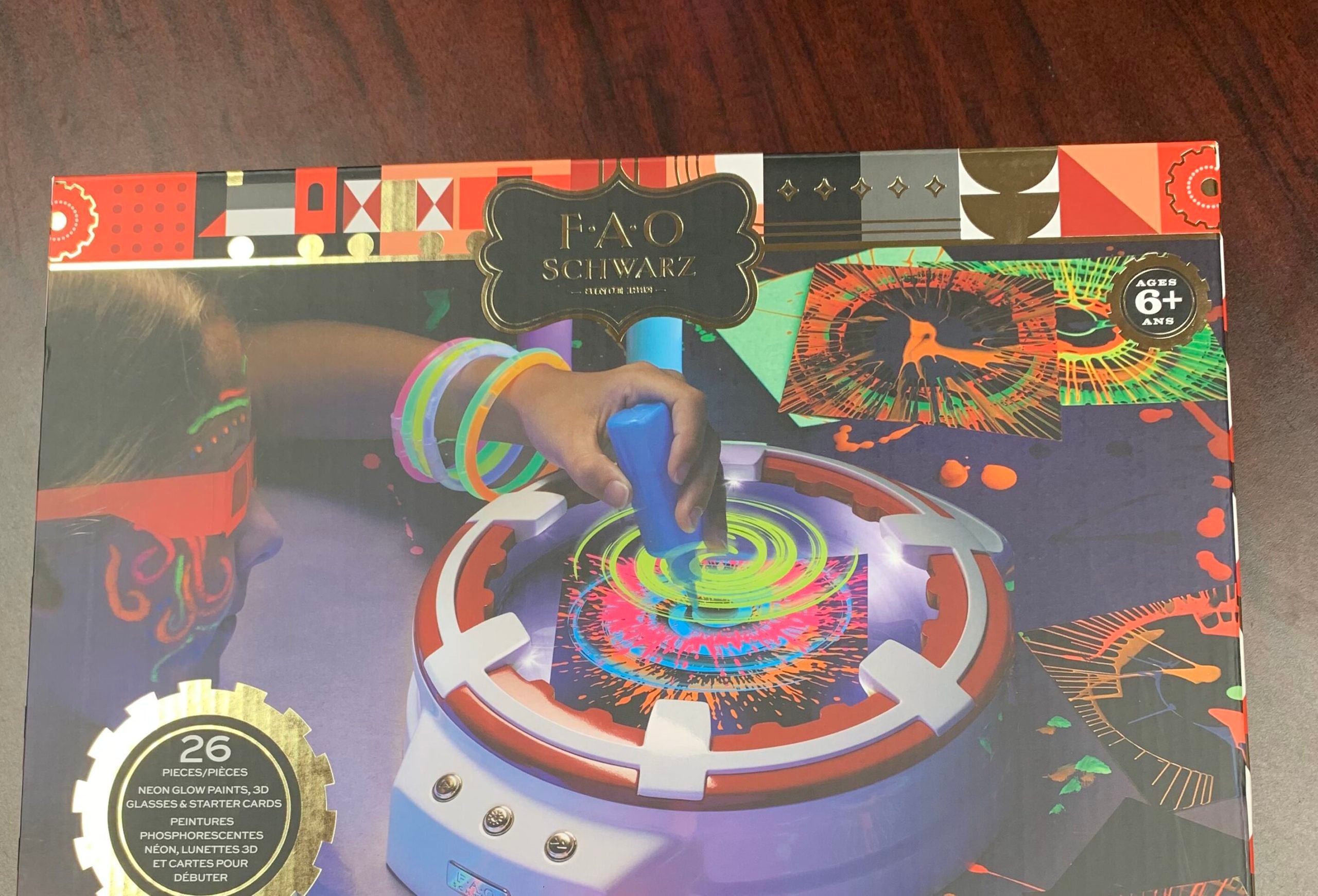 A FAO Schwarz spin art toy in its original box.