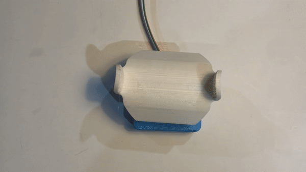 An animation of a hand gripping a u-shaped 3d printed topper of an analog thumbstick.