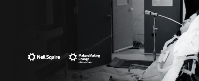 A black and white photo of Neil Squire in a wheelchair using a sip-and-puff device to type Morse Code. To the right are the Neil Squire and Makers Making Change logos.