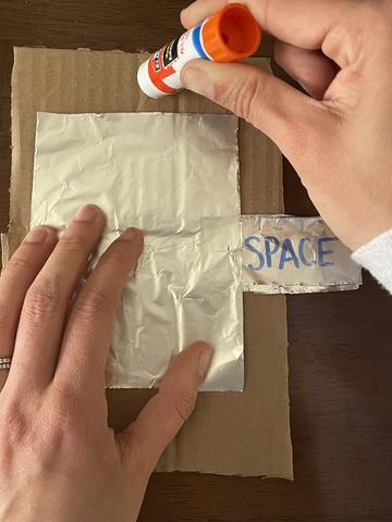 Putting aluminum foil onto glued area