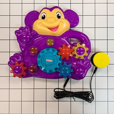 A MMC60 switch plugged into a plastic monkey toy with multiple gears on the front