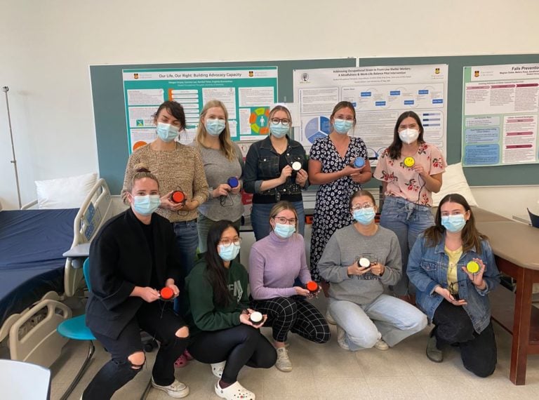 A group of participants holding their built devices in a classroom.