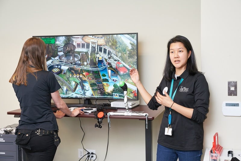 MMC staff Kristina and Zee showcasing our adaptive gaming setup.