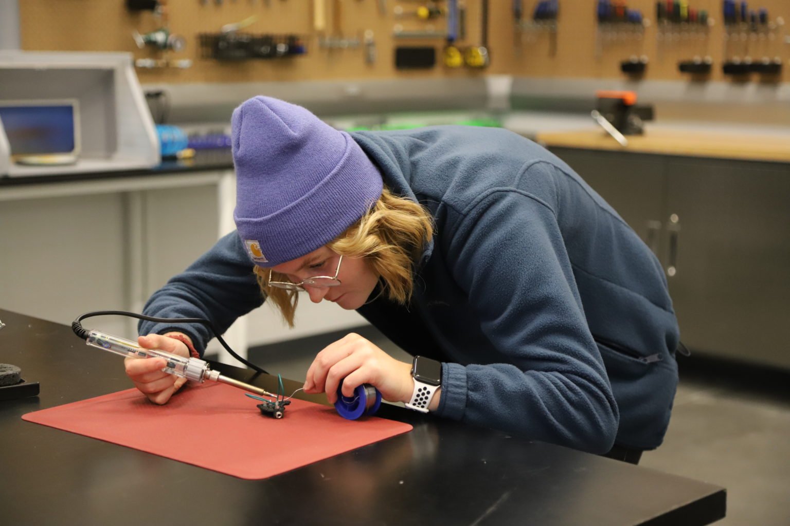Student soldering a switch