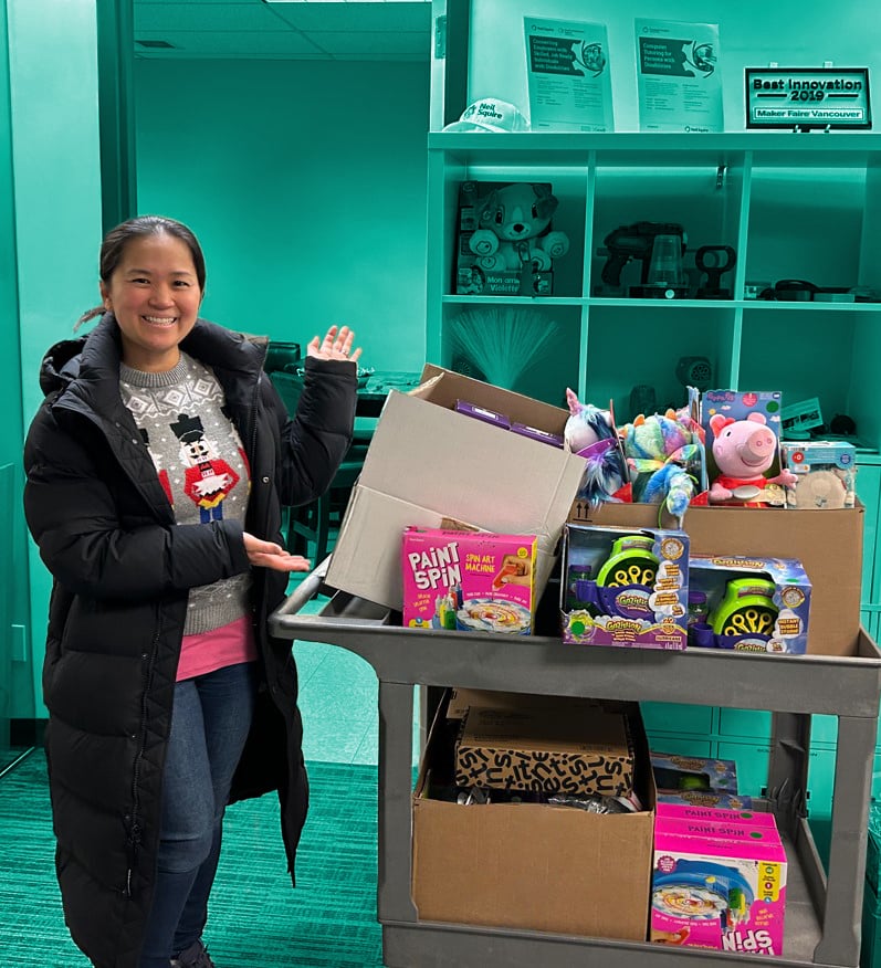 An occupational therapist with a cart of adapted toys