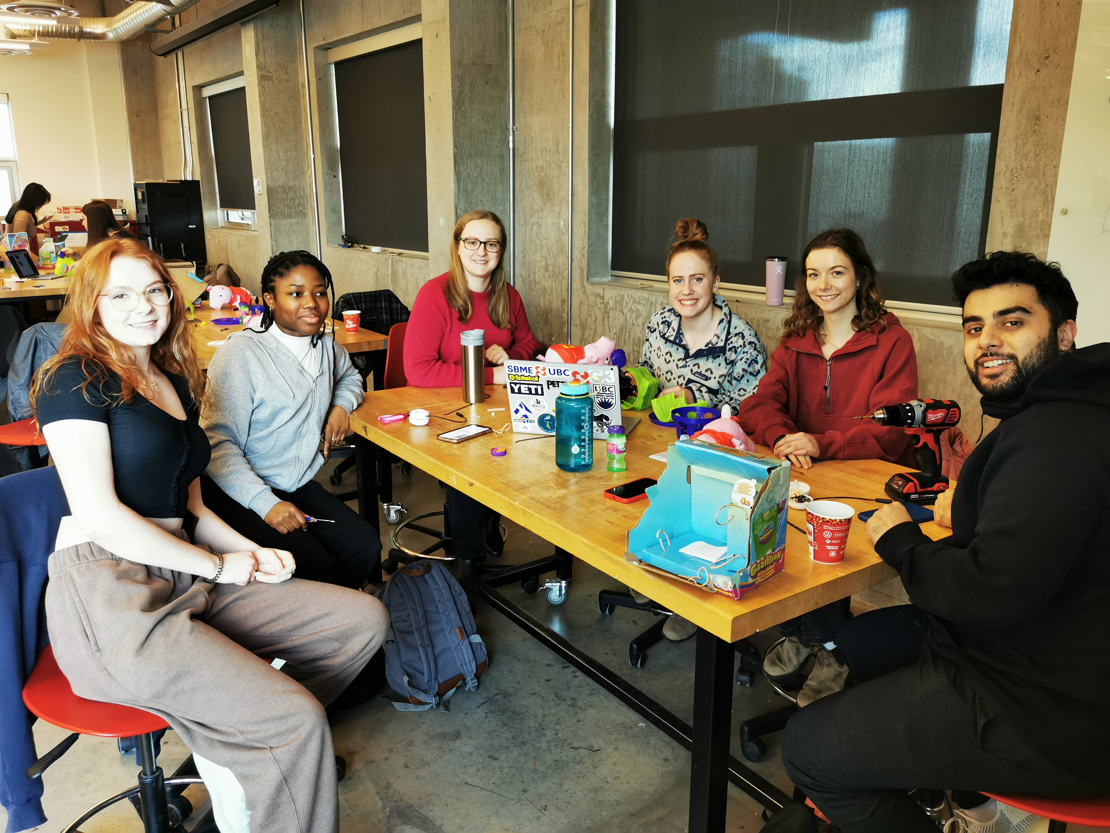 A group of students soldering adaptive devices.