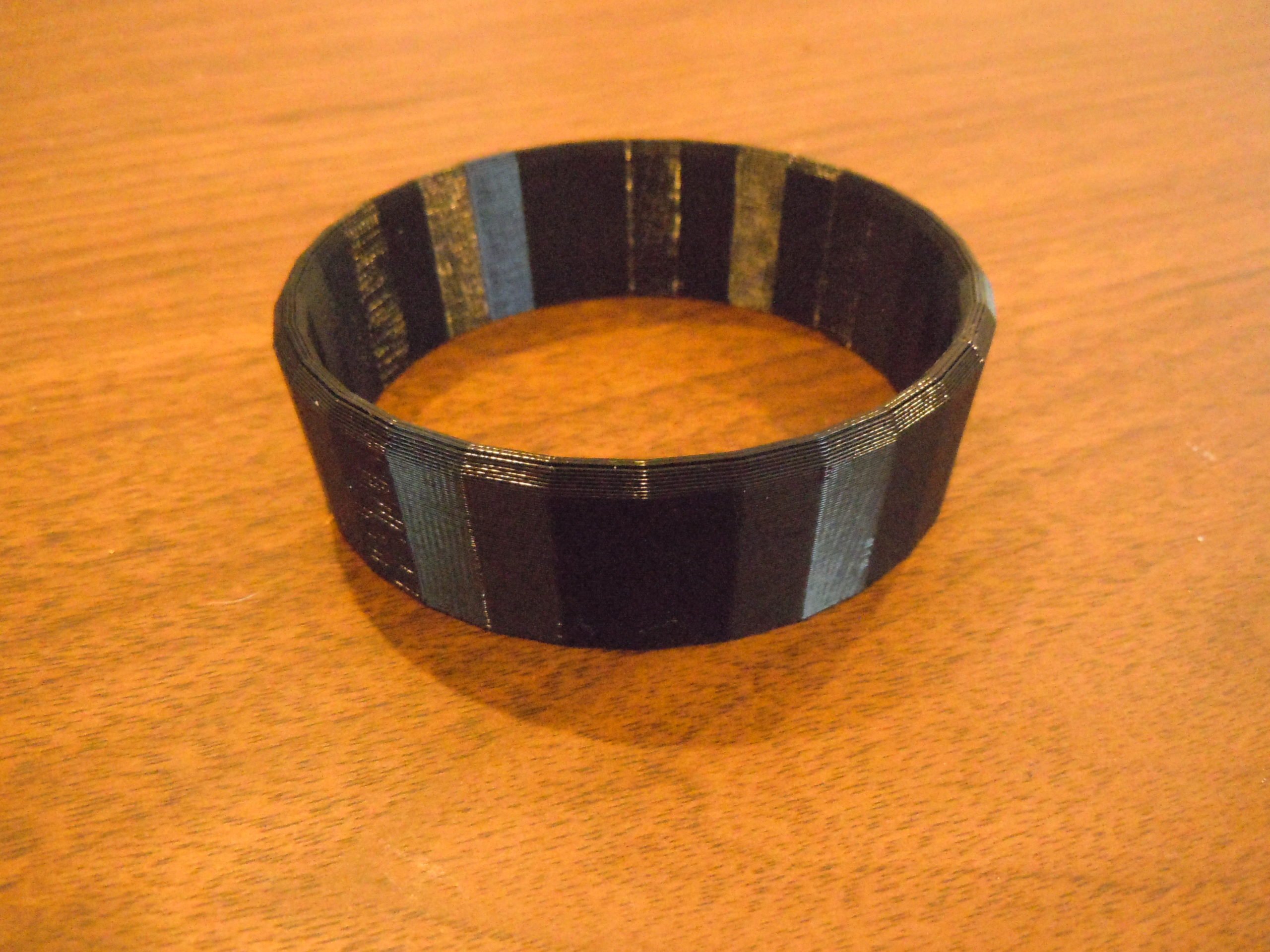 A black 3d printed cup holder resizing ring.