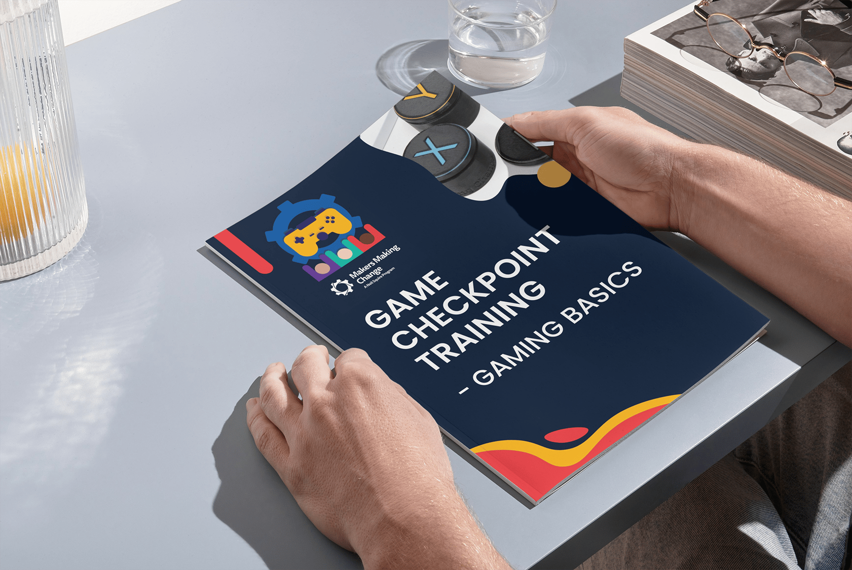 A hand holding the GAME Checkpoint Training booklet