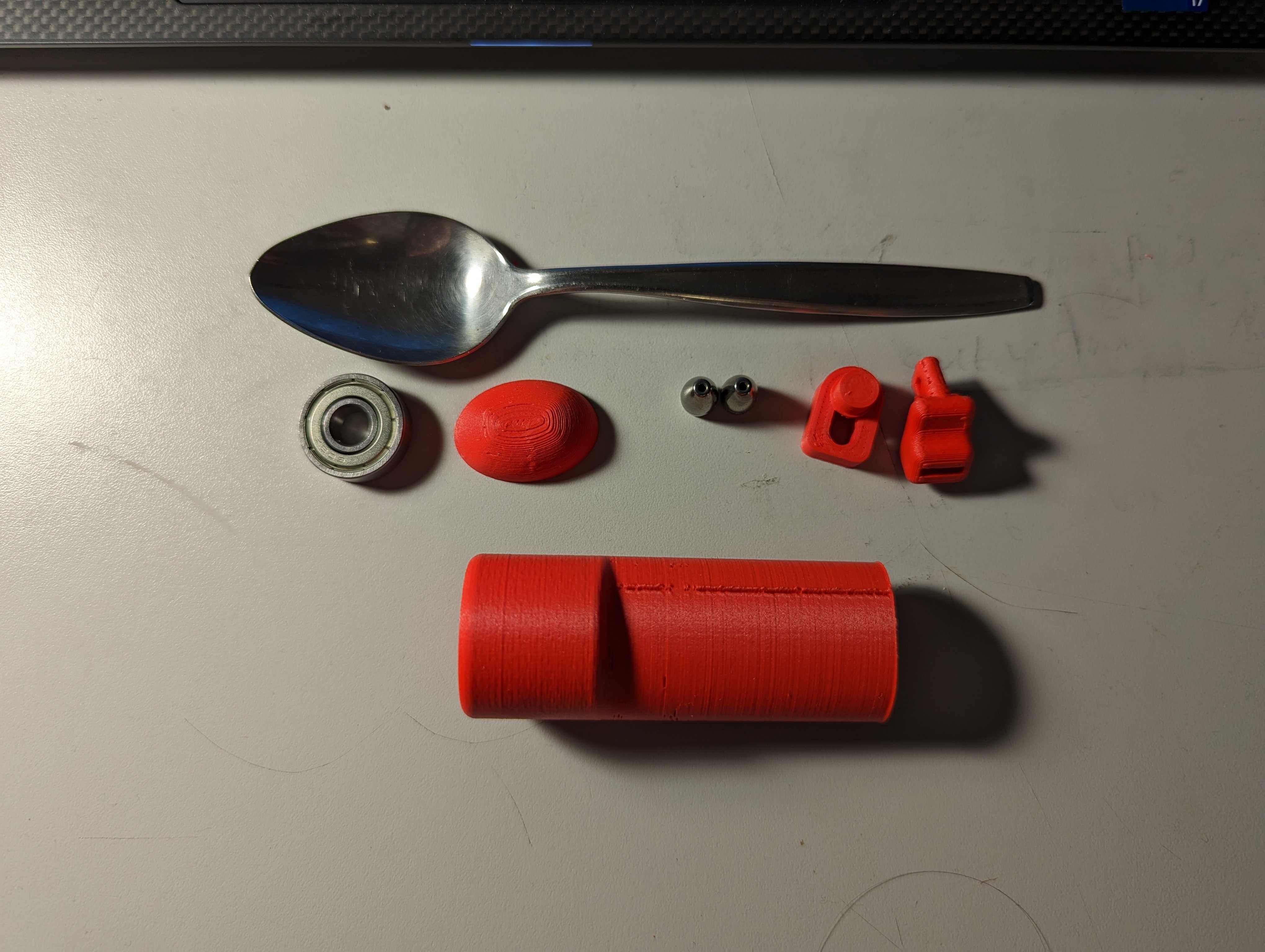 All the components for the spoon stabilizer support laid out beside each other on a table