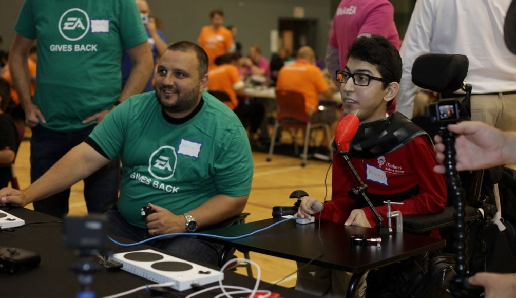 An EA employee and an MMC staff using an assistive switch.