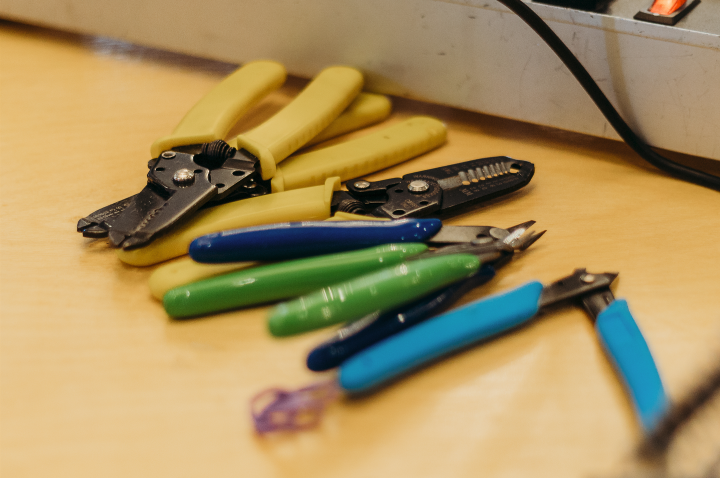 Wirestrippers and flush cutters on a table.