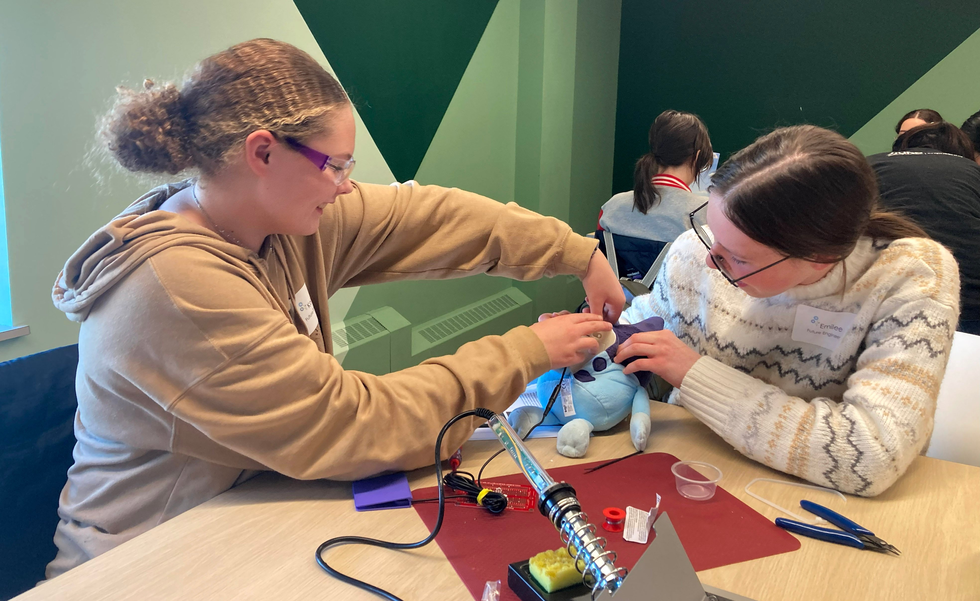 Two girls working together to adapt a toy