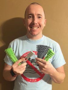 A volunteer holding up different 3D printed devices.