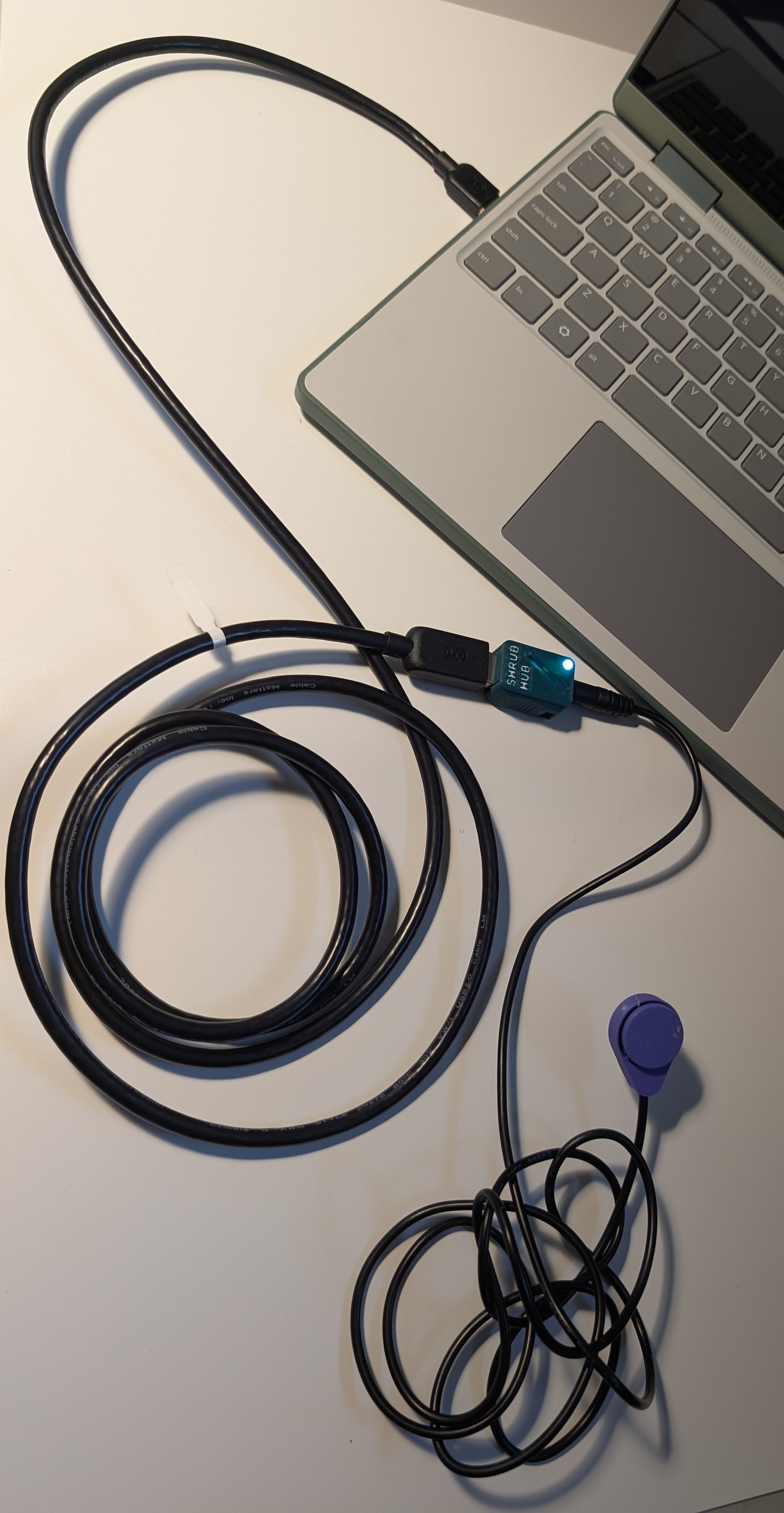 A shrub hub connected to a USB extender that is connected to a computer