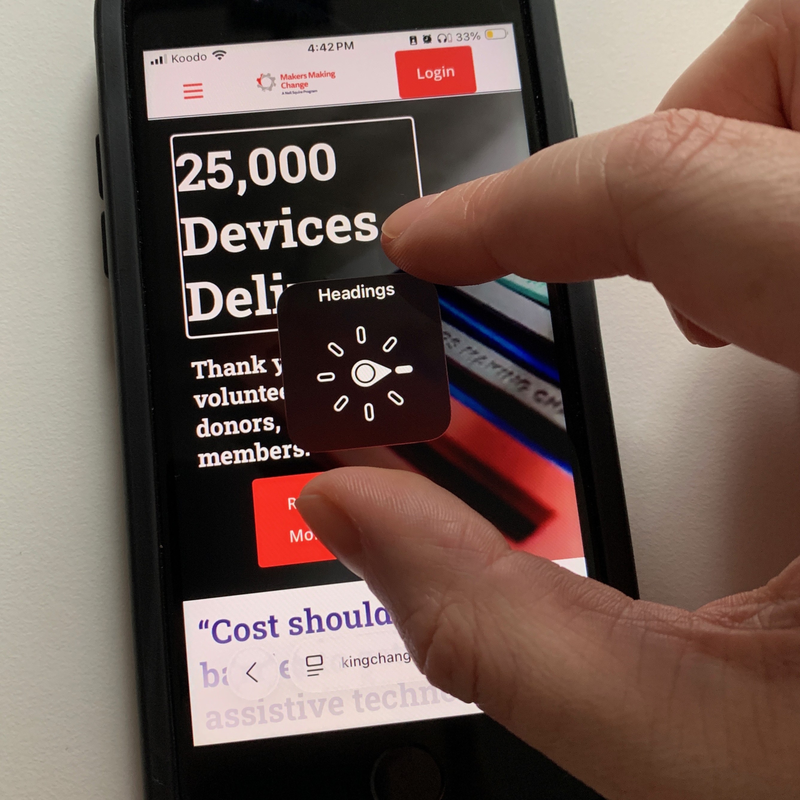 A person using two fingers to activate the rotor control in iOS Voiceover on a smartphone.