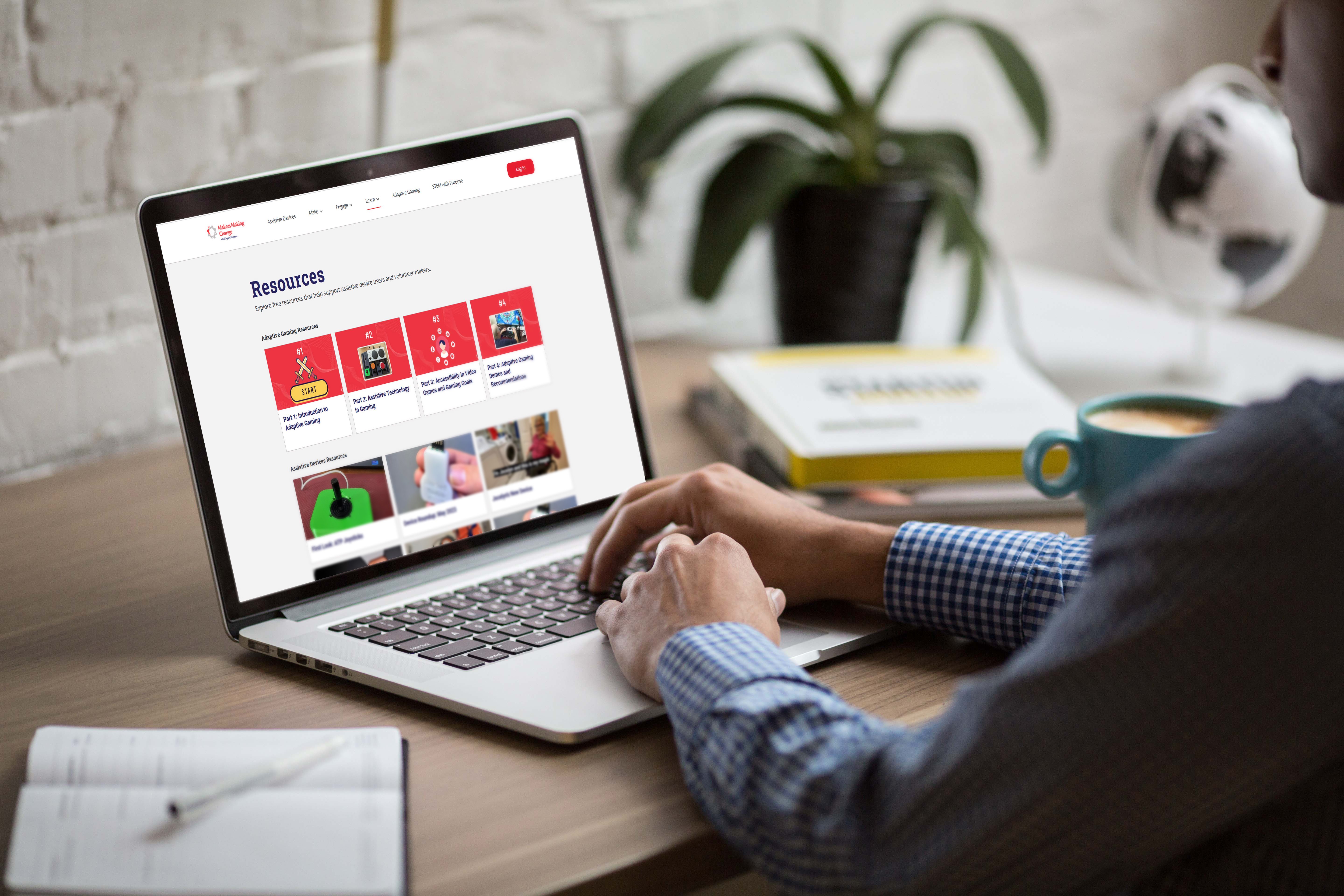A person looking at the Makers Making Change resource page on a laptop