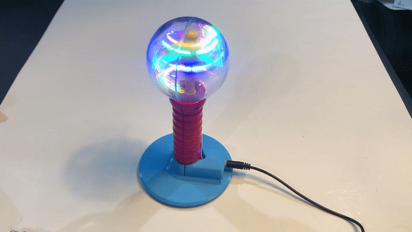 An animation of a switch-adapted spinning light want on a blue 3d printed base.