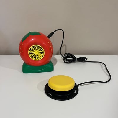 An interact switch plugged into a bubble machine shaped as a strawberry
