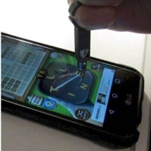 A finger stylus being used with a smartphone.