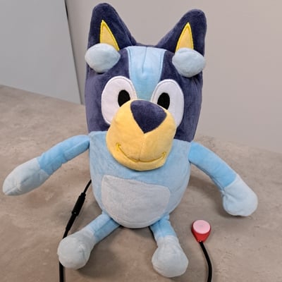 A raindrop switch plugged into a plush Bluey toy