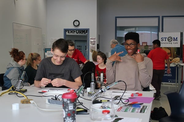 Two students making assistive devices.