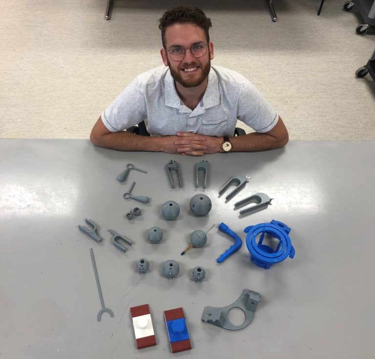 Lucas, a volunteer, pictured with grey and blue low tech AT.