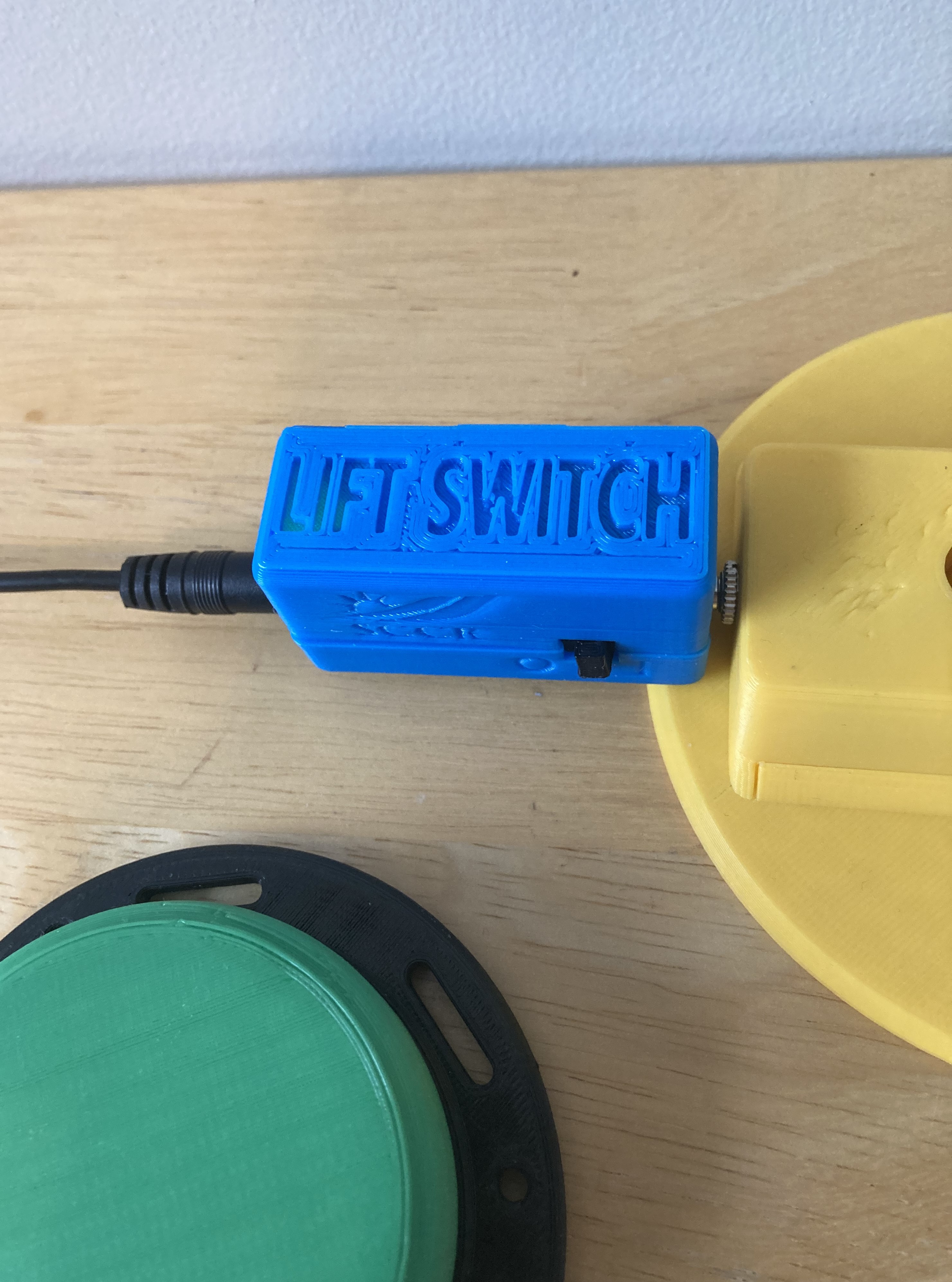 Close up of the Lift Switch plugged into a toy, with an assistive switch plugged into it
