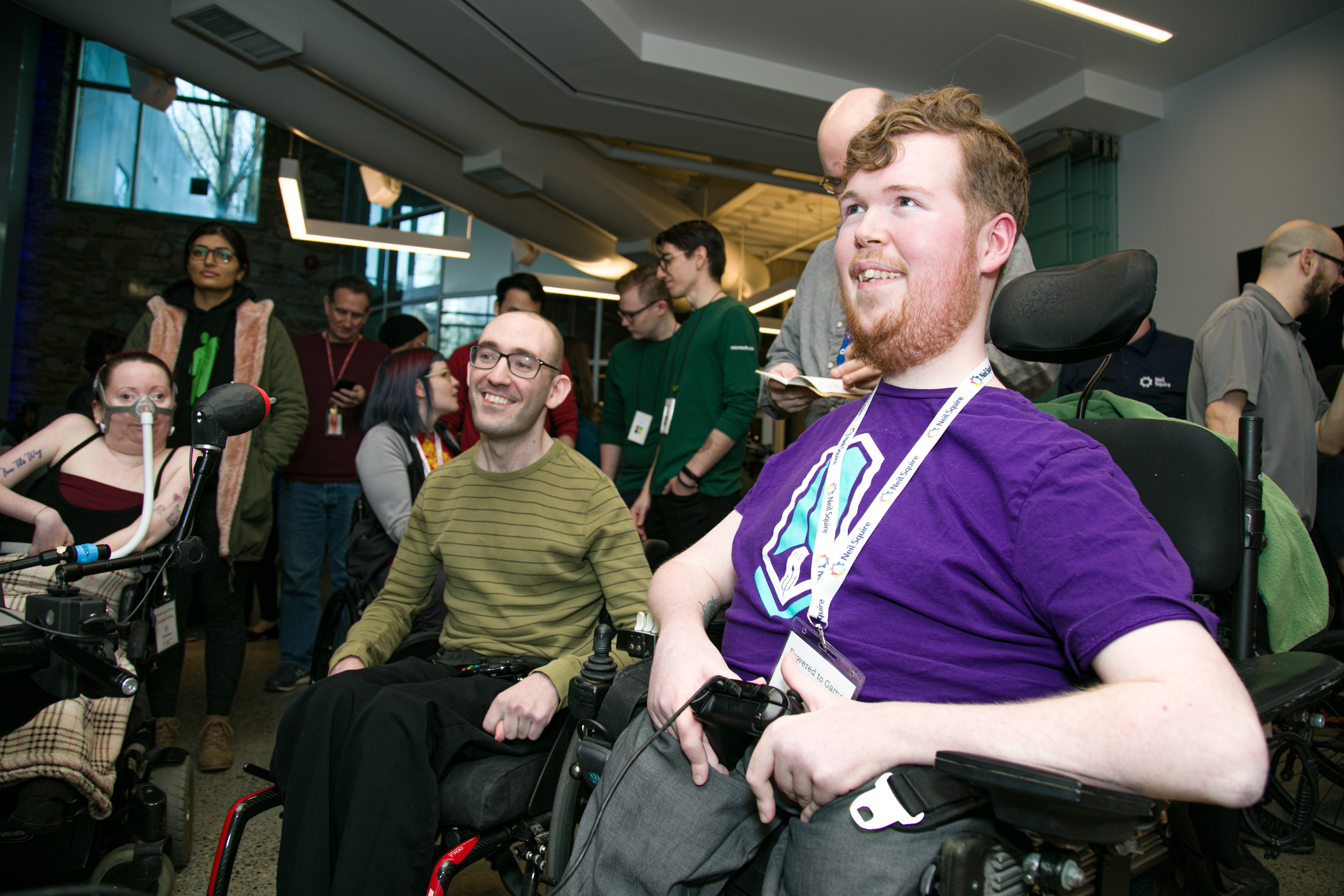 Three people gaming using adaptive gaming devices