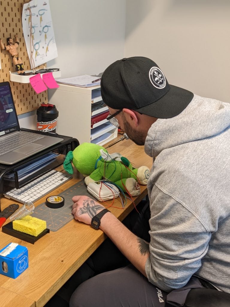 A volunteer adapting a toy.