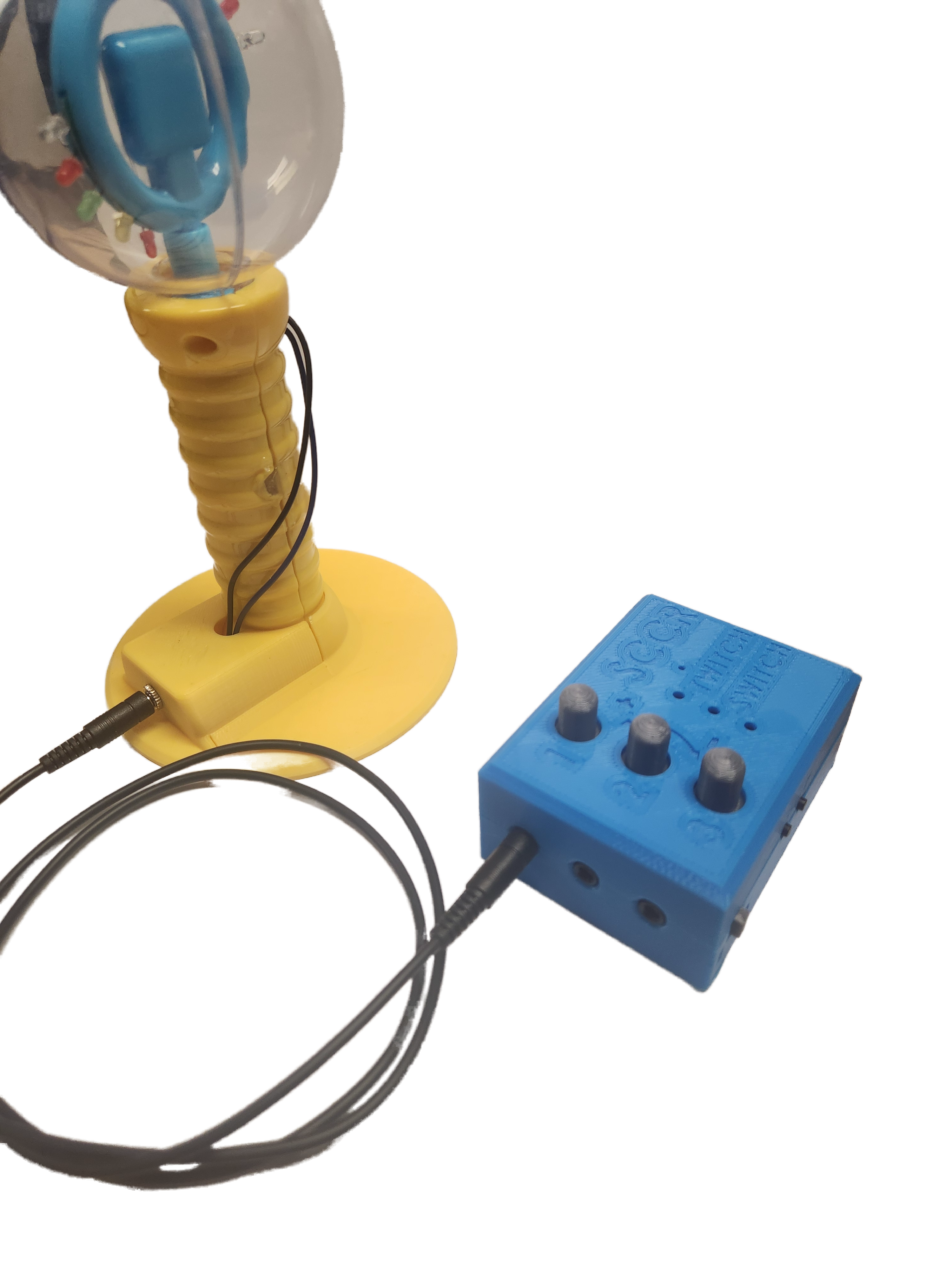 Blue Twitch Switch controller plugged into a yellow light up toy.