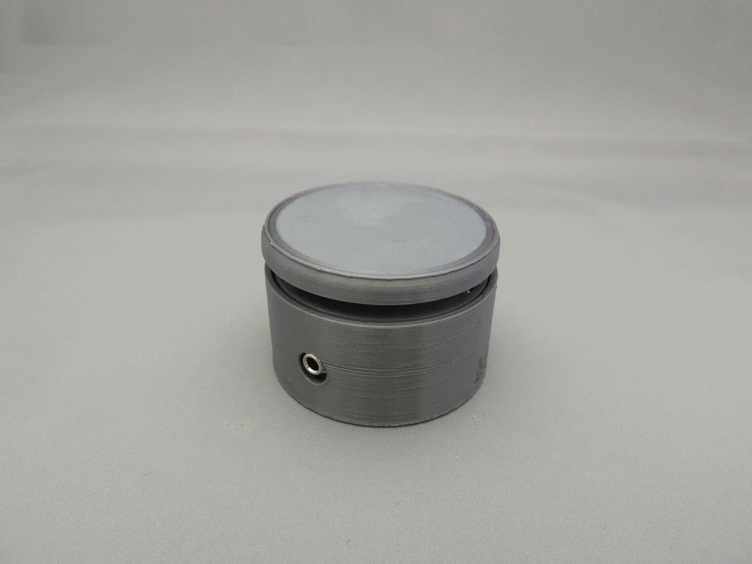 A grey MMC60 Assistive Switch with the 3.5mm jack visible