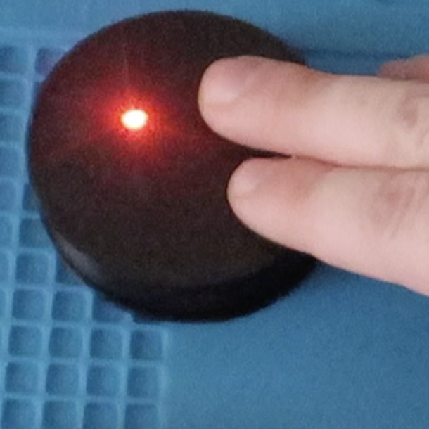 Two fingers activating a Round Touch 60 Assistive Switch