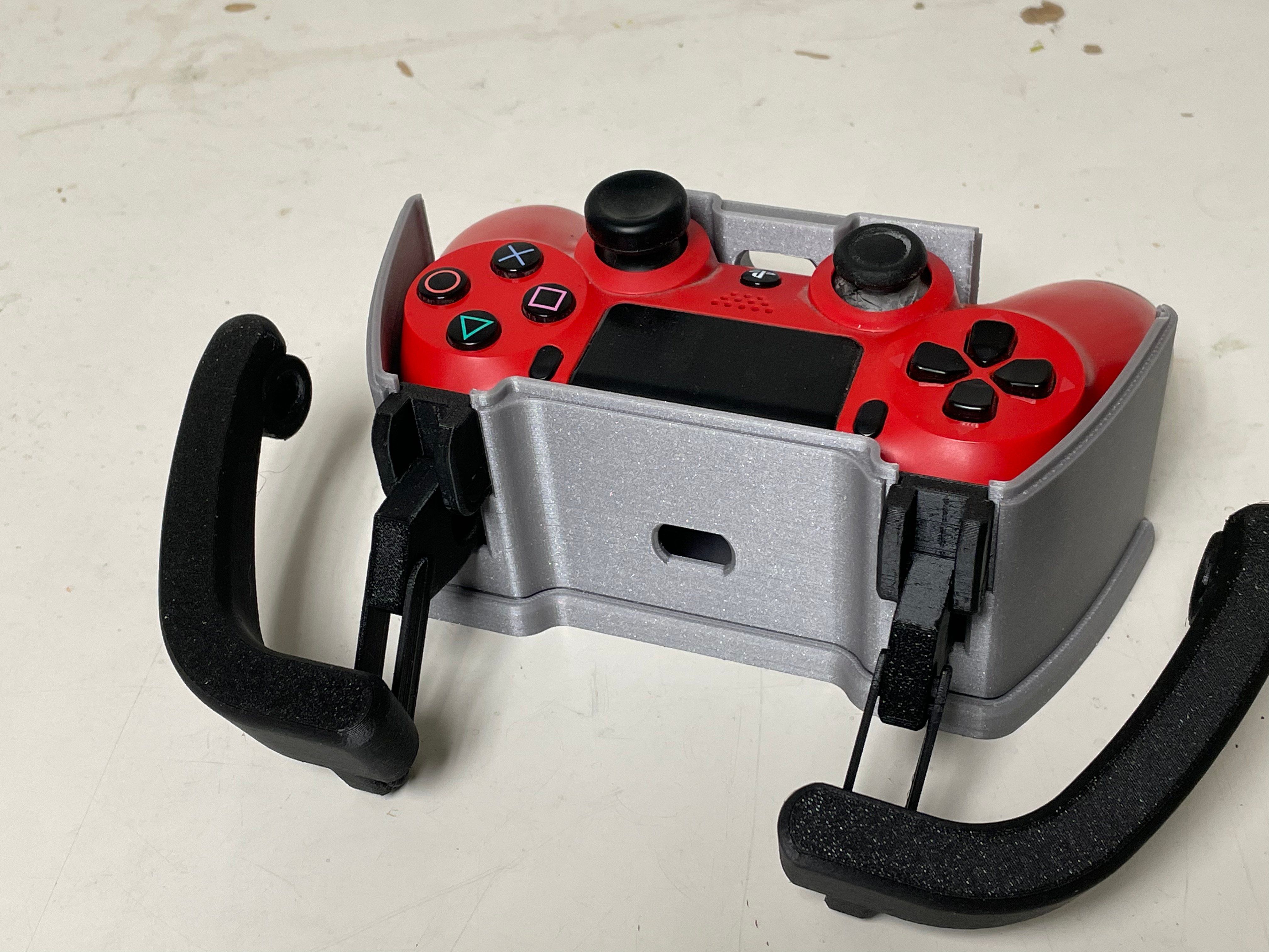 Red PS4 controller sitting inside the adaptive case with the lid of the adaptive case removed