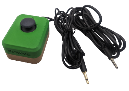 A Spruce Mini Joystick in a green and brown enclosure, with a TRRS audio cable and mono audio cable.