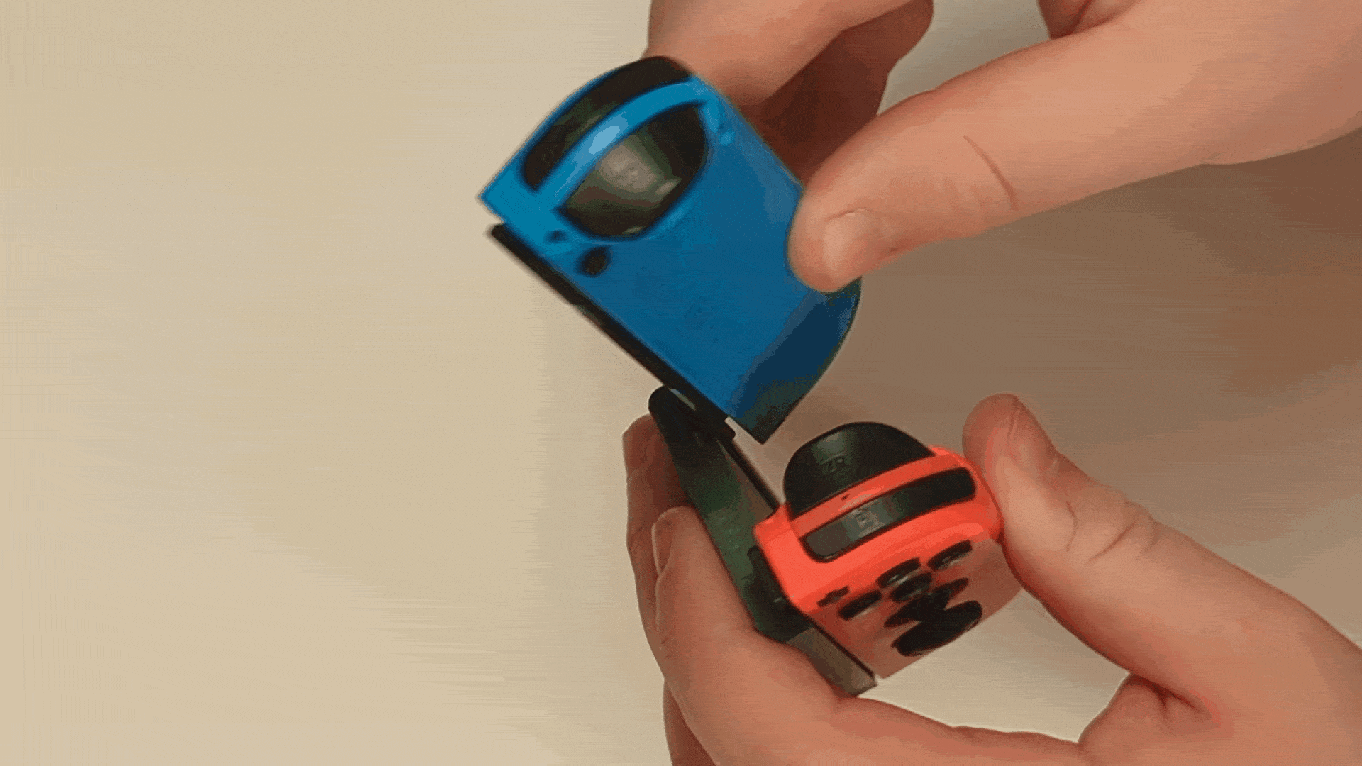 A gif of sliding the Nintendo joy-con into a 3D printed one-handed adapter and holding the controller with right hand.