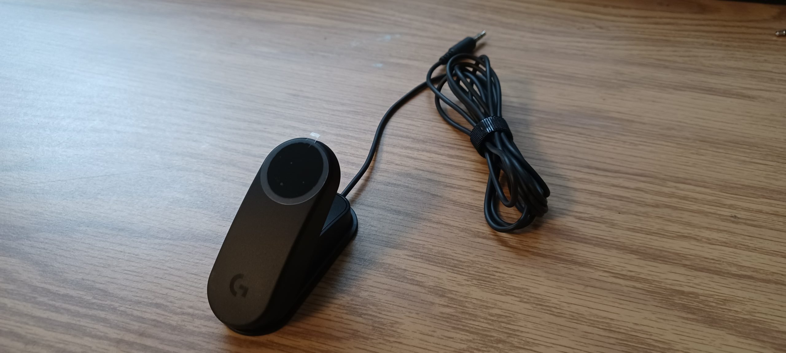 Logitech's variable trigger button against a wooden background.