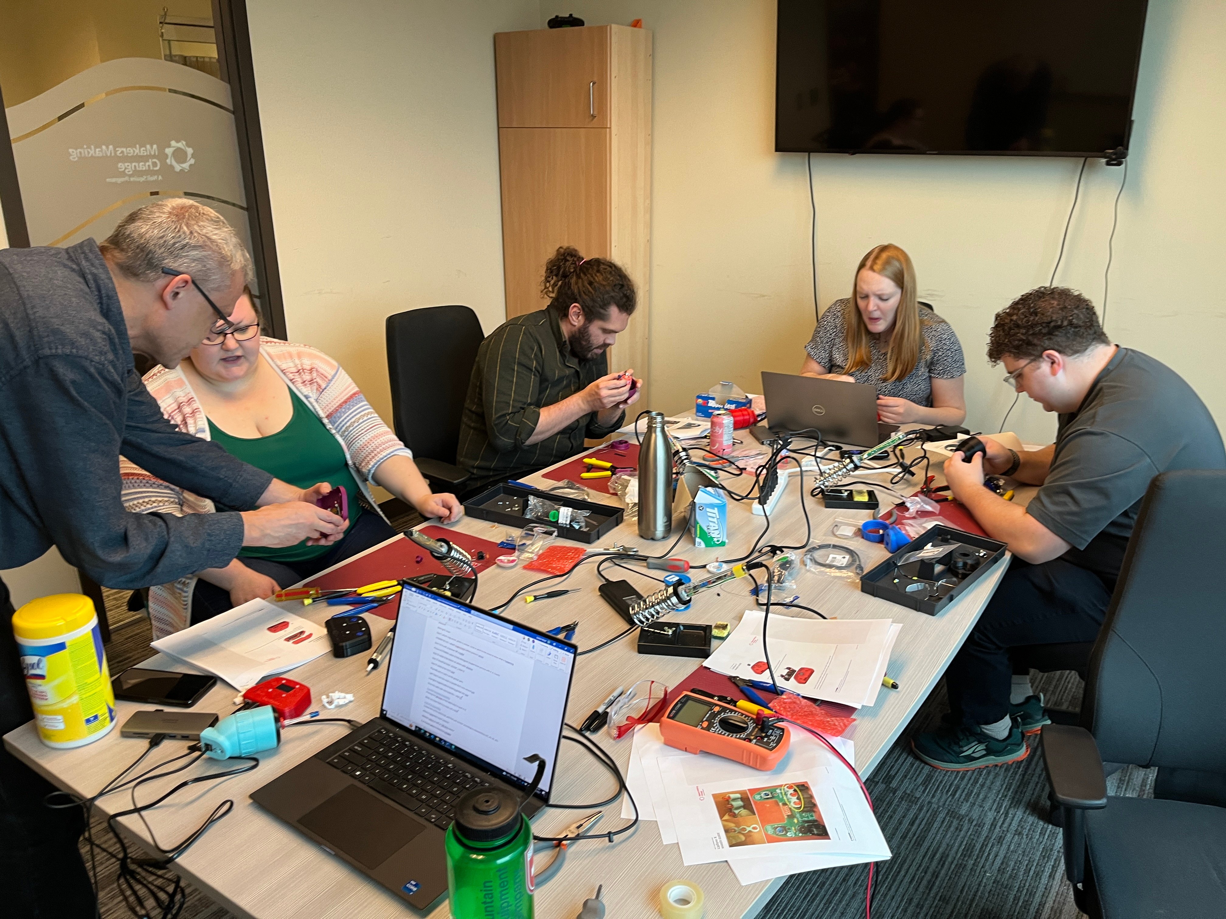 Makers Making Change staff building the Lipsync sip and puff device.