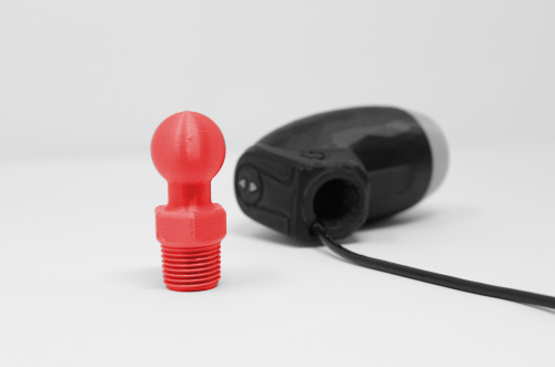 Photo of a 3d printed Ram-compatible adapter next to a LipSync