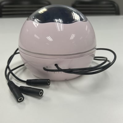 A round projector toy with three mono cables coming from the base of the toy